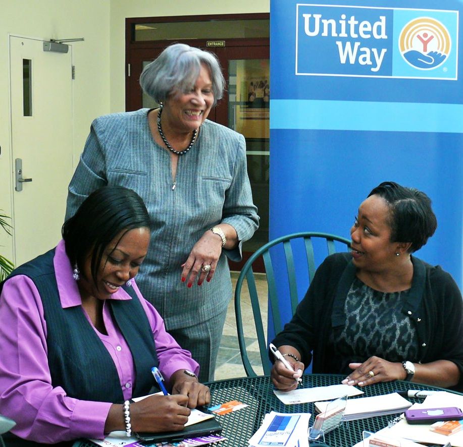 Innovative Customer Service Supervisor Kafi Armstrong and Vice President for Public Relations Jennifer Matarangas-King sign up for payroll deductions benefiting United Way of St. Croix, while United Way board member Ana Davila looks on.
