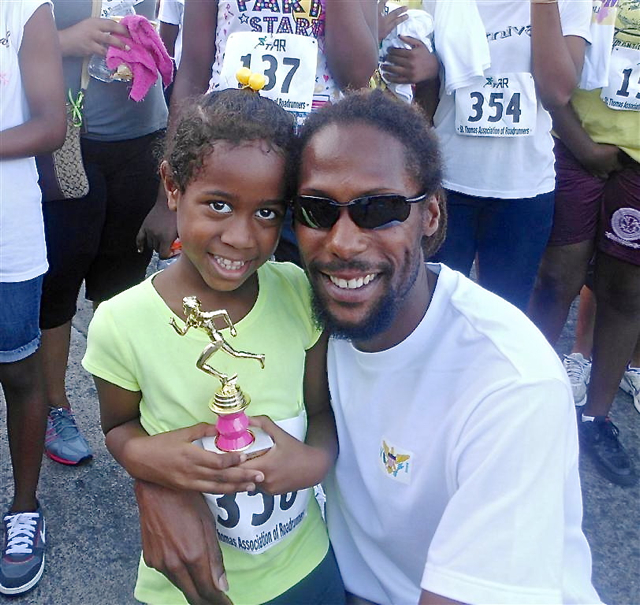 Six-year-old runner Devin DeGannes and proud father Shane DeGannes.