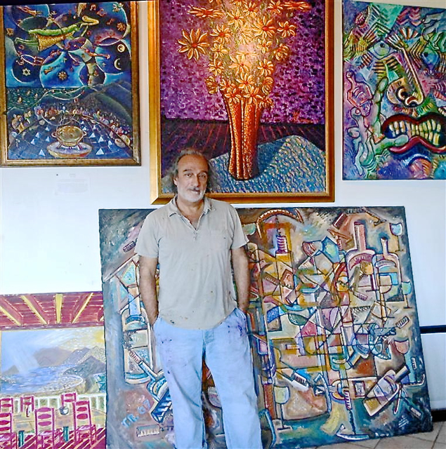 Tony Romano shows some of the work hanging in his studio.