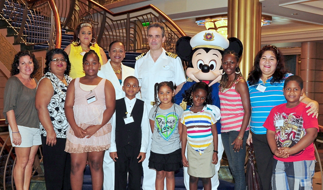 Top participants in th4e Summer Reading Challenge and their chaperones had a portrait taken with Mickey and Marco Nogara, captain of the Disney Fantasy.