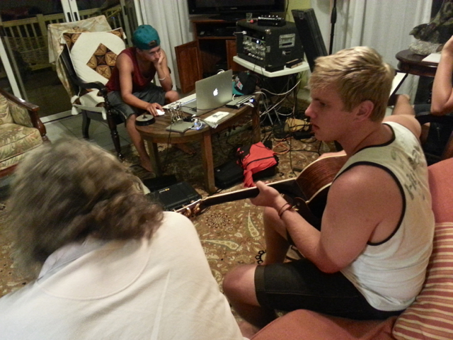 Matt Royer, left, edits a song while Keith Smith, known as Sno, plays and Sean Finnigan listens.