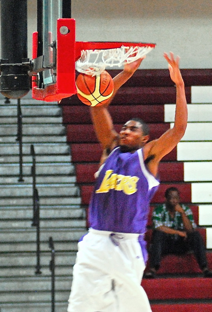 Lakers forward Charles Moorehead rams home a monster two-handed dunk.
