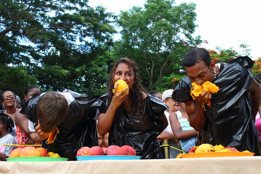The adult competitors couldn't keep up with Hector Gordon, right, who ate twice as many mangoes as anyone else.