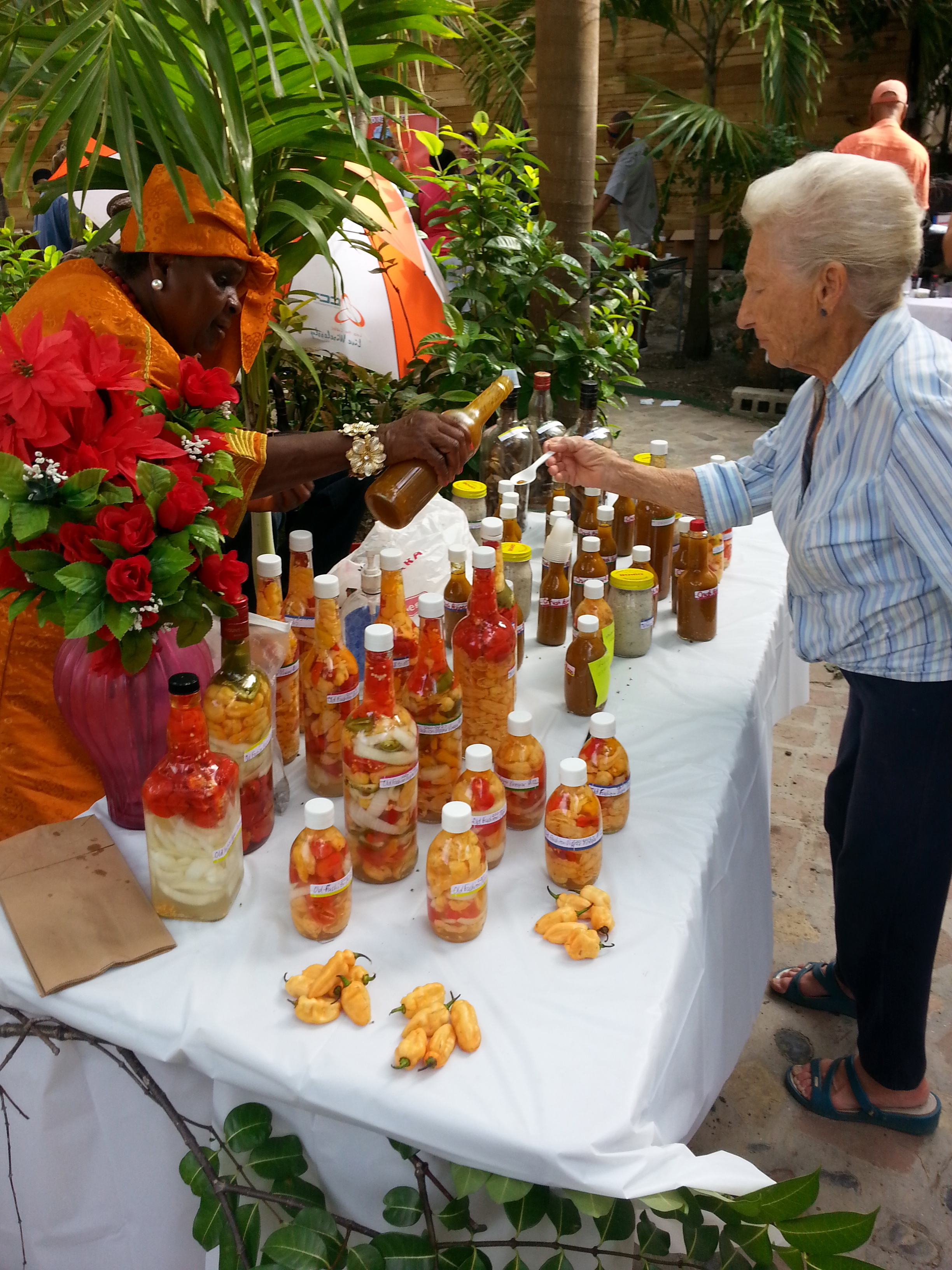 Theresa Davis pours a sample of her hot sauce.