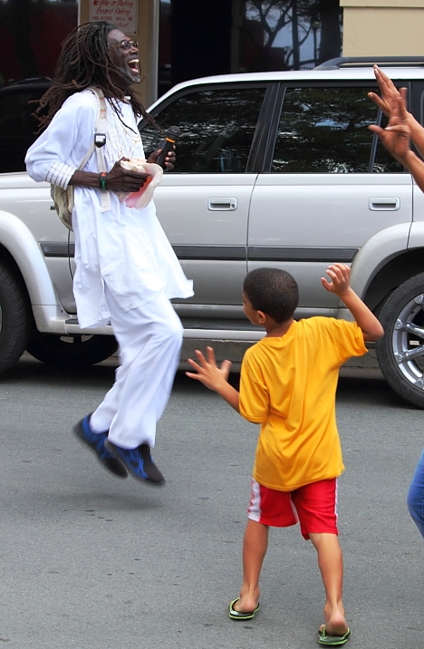 Sen. Terrence 'Positive' Nelson dances with children in the streets of Frederiksted after the 2013 Fort-to-Fort Walk.