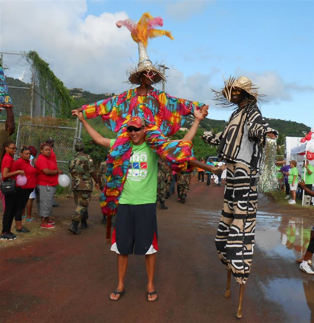 Mocko jumbies play at the Relay for Life.