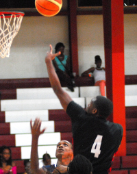 Saleem Ross of Boys Dem soars over Hoyas defense for two points.