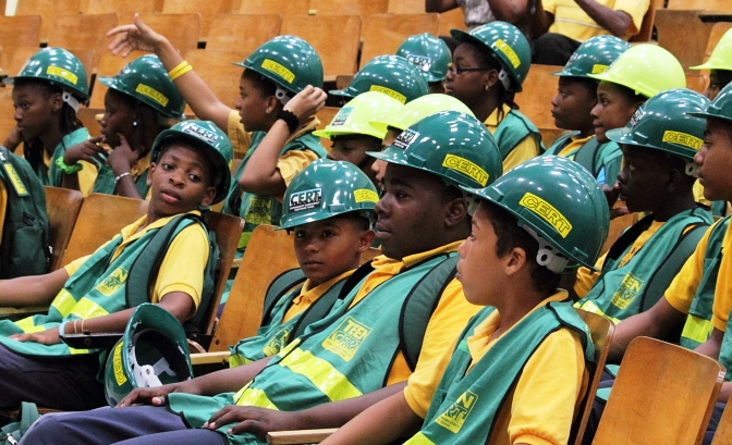 Teen CERT students in their green hard hats and vests watch the ceremony from the front row.