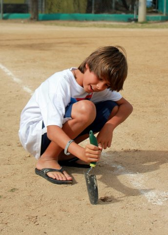 Charlie Palminteri scrapes up some dirt at Winston Wells Ballfield for his science project. (Photo provided by Dr. Laura Palminteri)