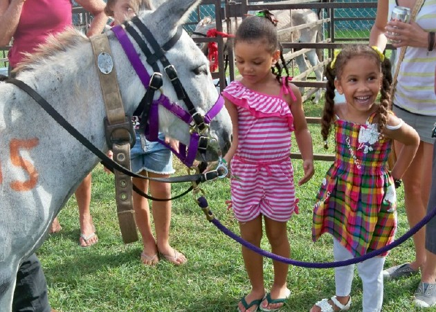 Keren Walker, left, and Zoe Cooper meet one of the racers.