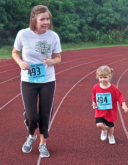 Paige Autry and three-year-old Charlotte Beck take a lap.