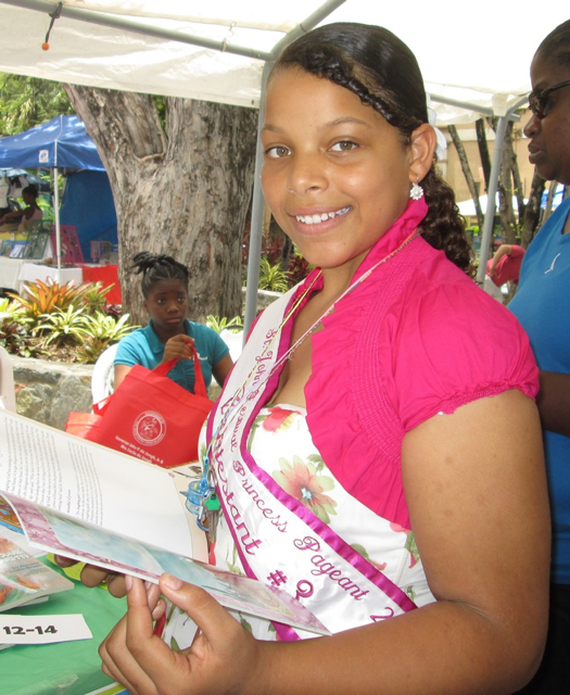 Liliana Remington, 11, pauses while signing up for the Summer Reading Challenge.