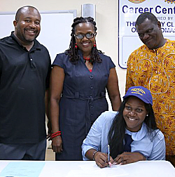 CAHS Athletic Director Myron Corbett (left), parents Ufakobong Utibeabasi and Utibe Utibeabasi join Edidiong Utibe signing a letter of intent.