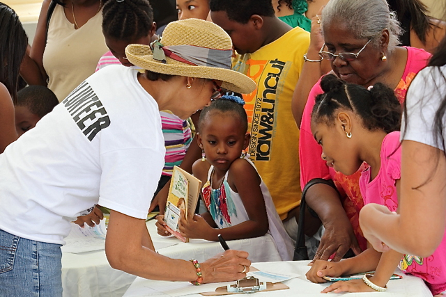 Kids sign up for the Governor's Summer Reading Challenge Saturday at Sunny Isle.