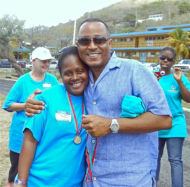 Finance Commissioner Angel Dawson, who volunteered at Saturday's games, congratulates the aptly named Rosemary Dash, winner of 100 meter-race. 