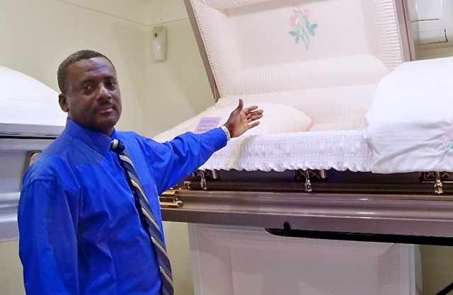 Eldon Rey displays a casket.