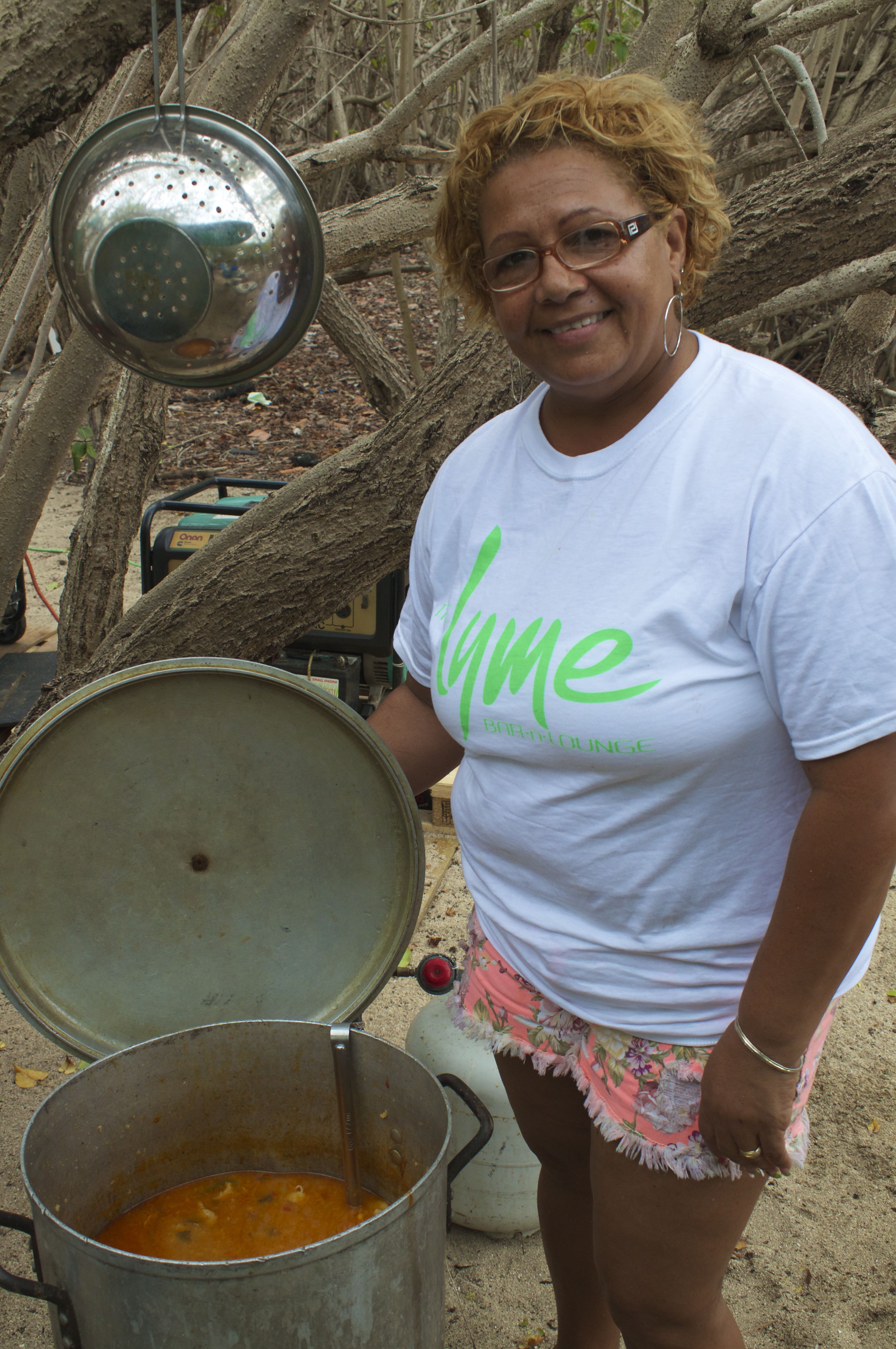  Yvonne Ortiz, owner of El Flamboyant Restaurant, serves her famous chicken soup to visitors to her camp.