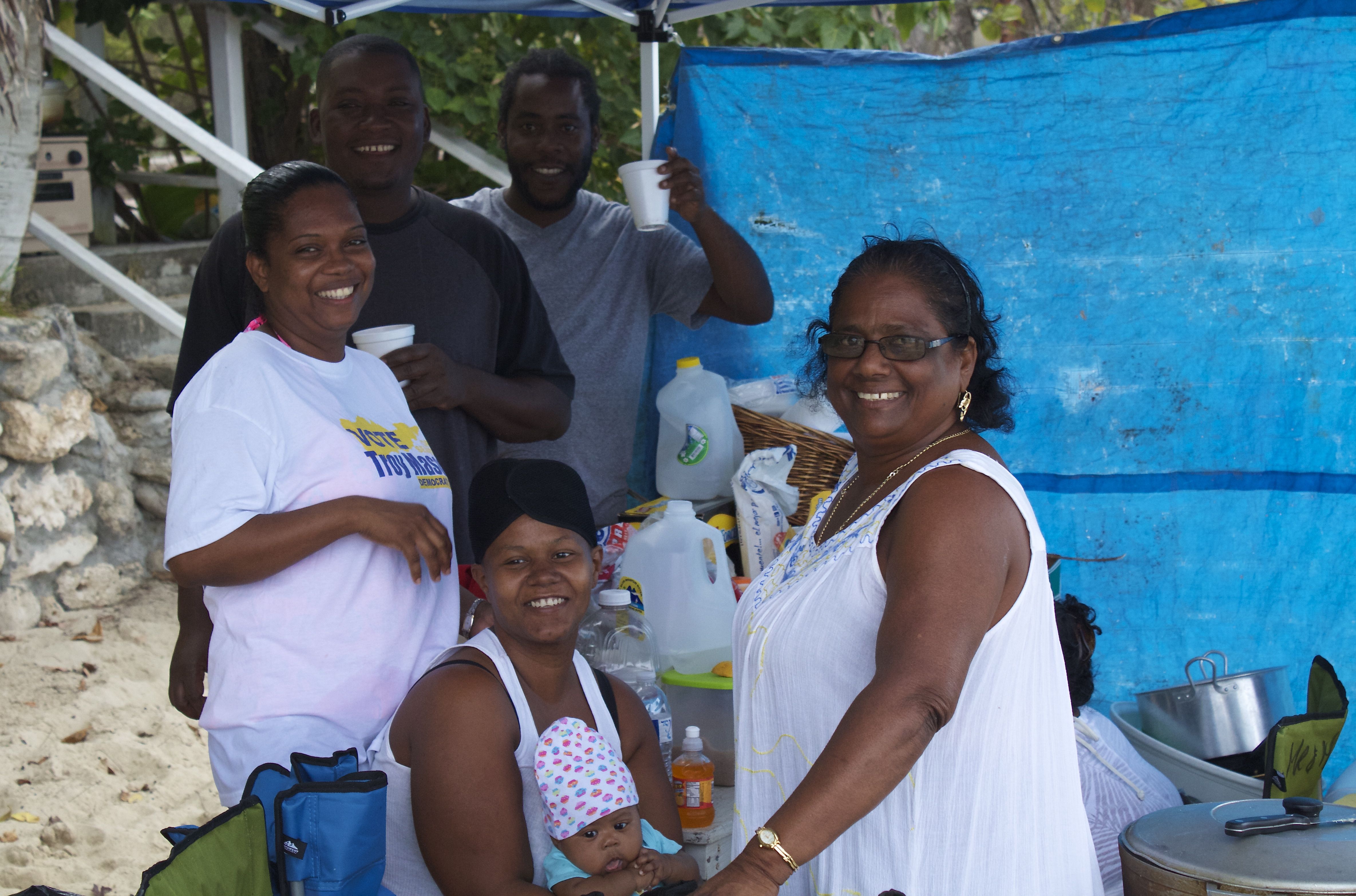 The William family gathers under their tent as it begins raining on Sprat Hall Beach.