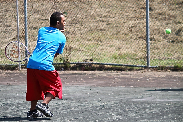 Jordan LaCoss lines up a shot during the tennis competition.