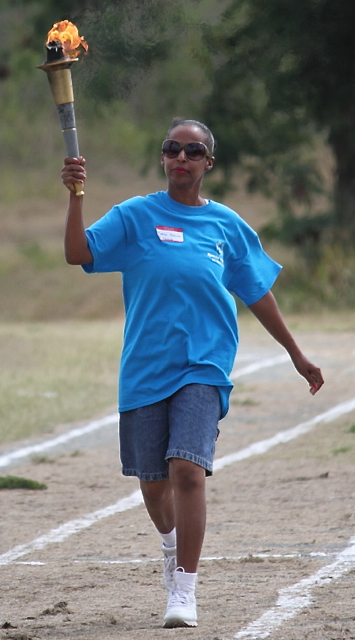 Medina Roberts carries the torch during the opening ceremonies of the Special Olympics.