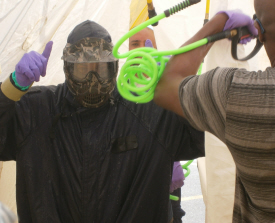 A V.I. Police officer gets decontamination training following a simulated chemical weapons attack.