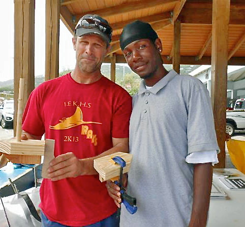 IEK marine instructor Stanley Lorbach, left, and student Kolanni Edwards, helped assemble wooden boats.
