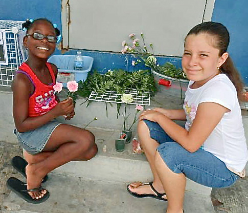 Briana Burgin, left, and Christa Greaux make floral arrangements.