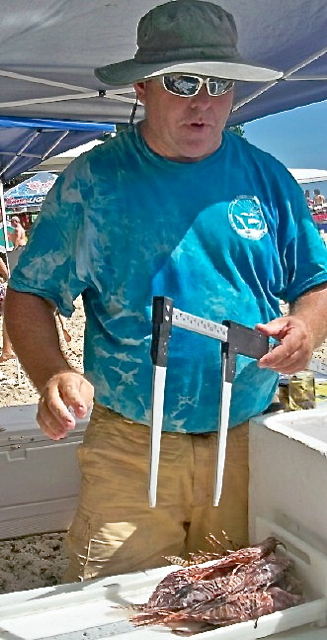 Biologist William Cole of DPNR weighs the lionfish harvest.