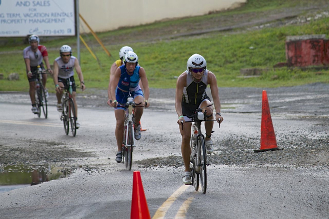 Racers carefully navigate a stretch of gravel-strewn roadway. Debris washed out by rain felled many riders.