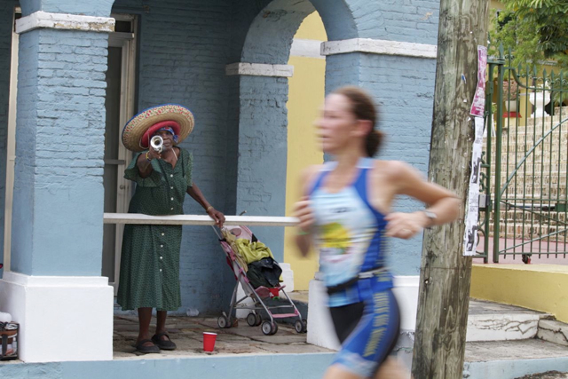 A spectator with a horn toots her support for the athletes.