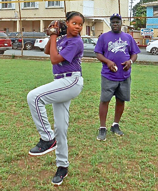 Michael Bute keeps an eye on Janiya Victor as she pitches.