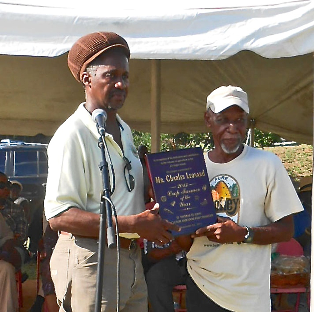 Agriculture Commissioner Louis Petersen, left, presents plaque to Crop Farmer of the Year Charlie Leonard