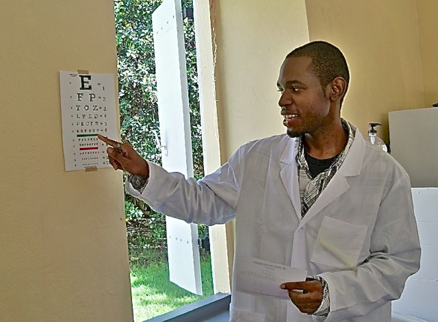 Optician Dorian Foster gives a vision screening.