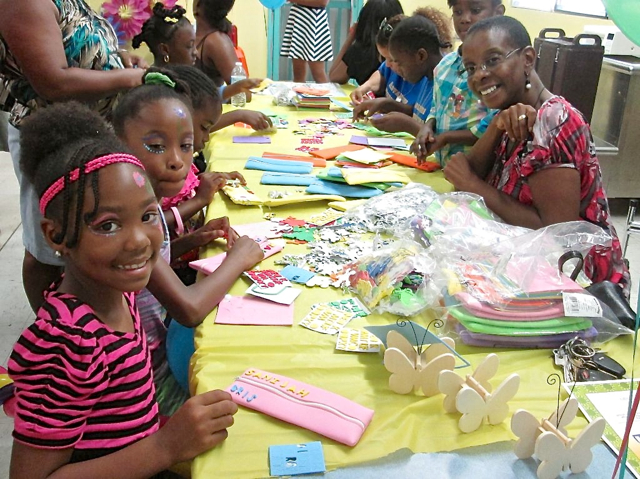 Arts and crafts with Guy Benjamin School Principal Brenda Dalmida, right, supervises pencil case decorating.