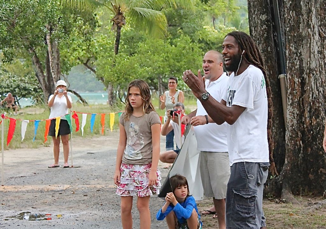 Race director Shane DeGannes cheers on runners at the finish line.