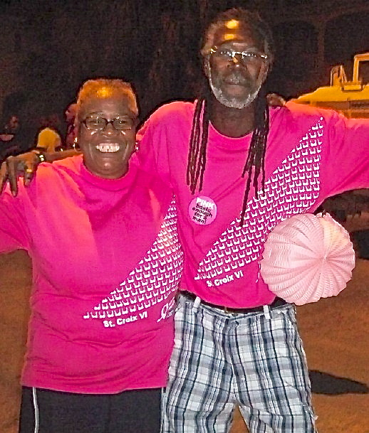 Michelle Gibbs and Sen. Terrence 'Positive' Nelson dance down King Street.