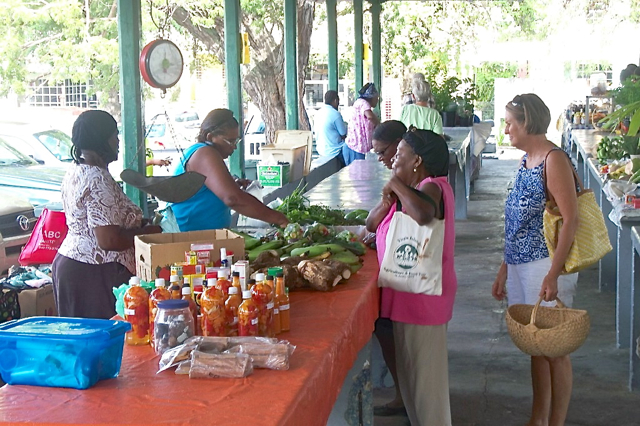 Customers buy produce at the refurbished Christian ‘Shan’ Hendricks Market.