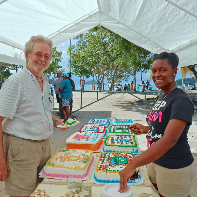 Judge Tom Moore accepts birthday cake from Veneta Frett at the October Sunday music festival.