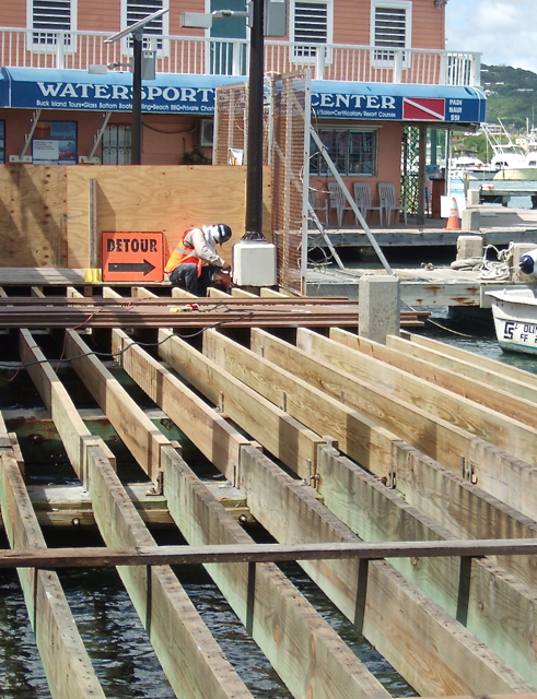 A J. Benton Construction employee works on the new deck at the east end of the Christiansted Boardwalk.