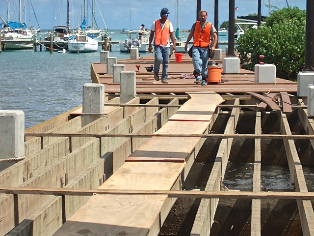 Workers at the west end of the Christiansted Boardwalk, near the Seaplane terminal, Saturday.