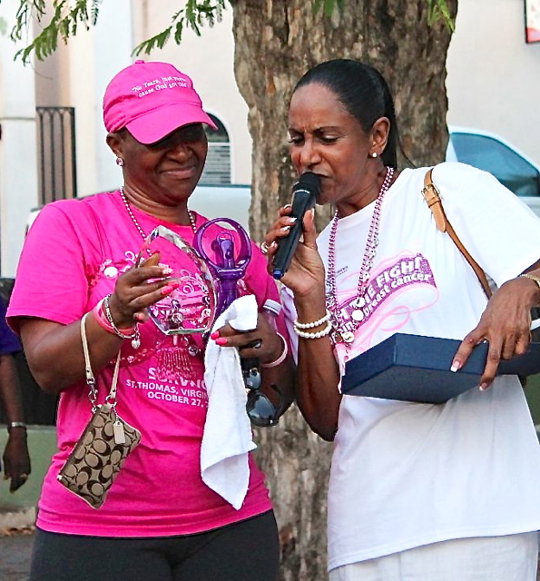 Cancer survivor Raynette Cameron, left, receives an award from ACS executive director Lorraine Baa.