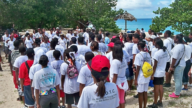 ROTC members form up at Vincent T. Mason Coral Beach Resort after cleaning a stretch of coast.