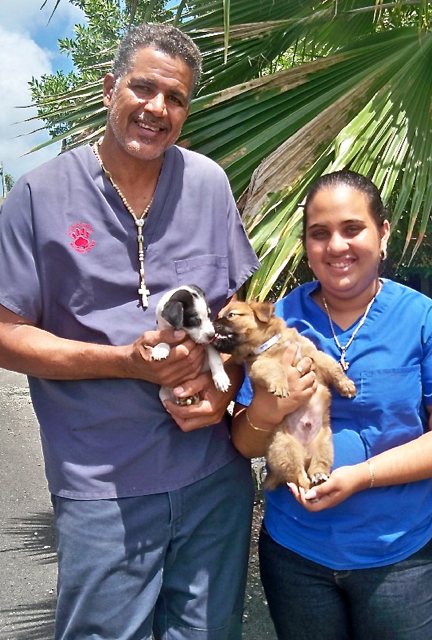 AWC animal control coordinator Moises Carmona, and adoption coordinator Shanice Seeram, with a pair of puppies looking for a home.