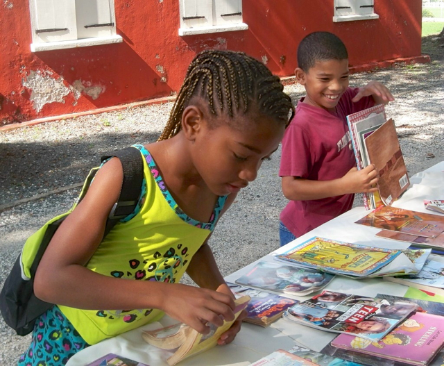 Karibel Manon, 8, and Jorge Sanchez, 6-years-old look over the free books.