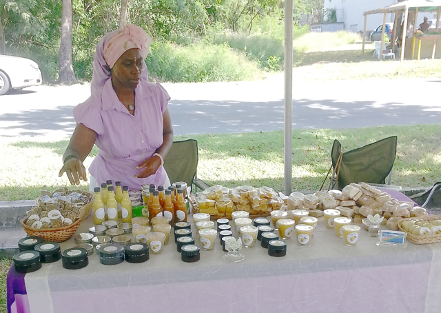 Violet Drew displays a tableful of honey and beeswax products at the Beekeepers' Buzzaar.