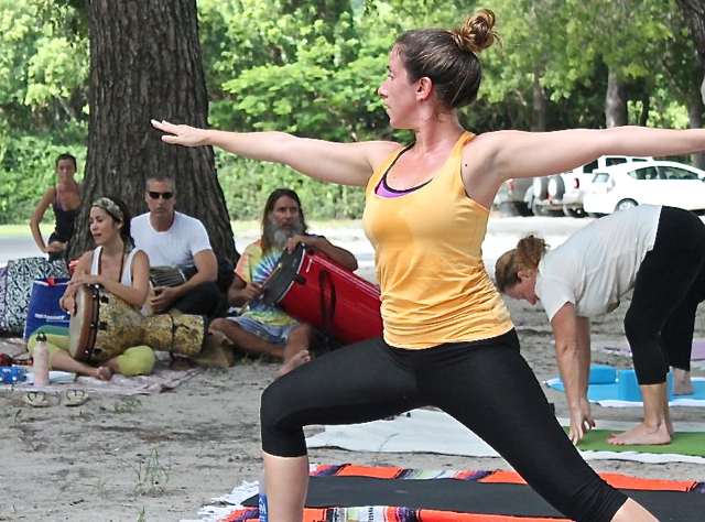 Yogis strike a position at the VI Global Mala Yoga Sunday in Magens Bay.