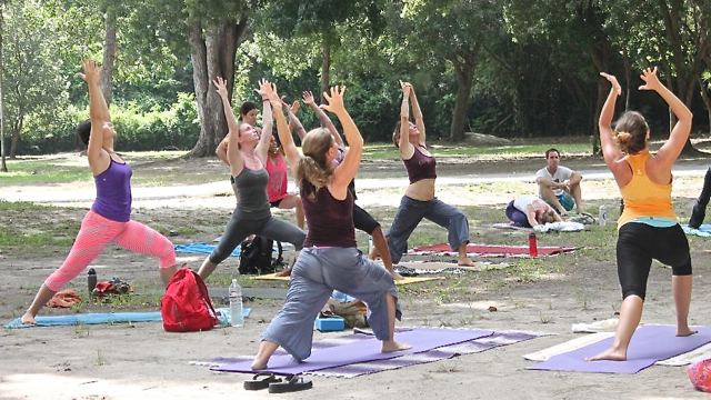 Yogis perform sun salutation postures. 