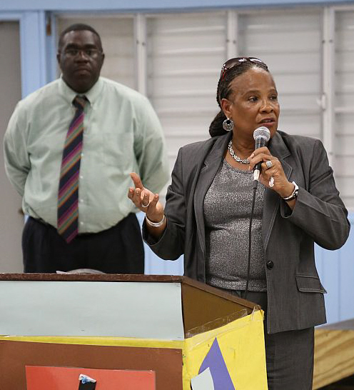 Jeanette Smith-Barry speaks to parents Monday while Gomez principal Jamon Liburd looks on.