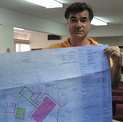 Architect Michael Milne with plans for the project.