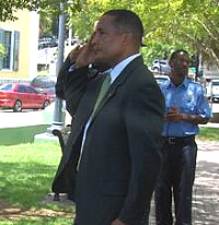 Sen. Louis P. Hill salutes at the Friday ceremony.